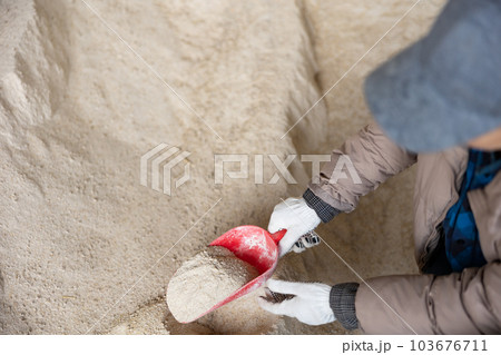 Scoop with corn germ meal in hands of female farmer 103676711