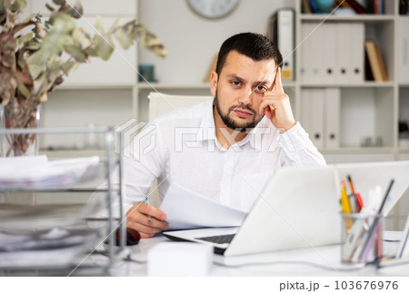 Portrait of tired man accountant 103676976