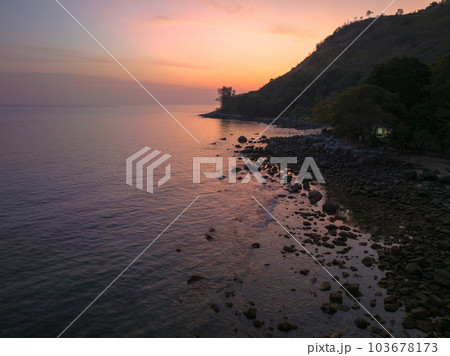 aerial view the sun going down in colorful sky impact on ocean surface The beauty of the cliff fits perfectly with the charming nature in beautiful sunset. cloud scape background aerial view the sun going down in colorful sky impact on ocean surface The beauty of the cliff fits perfectly with the charming nature in beautiful sunset. cloud scape background 103678173