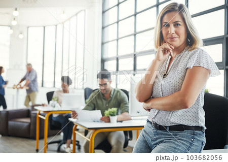 Creative business woman, smile and arms crossed thinking of idea in leadership or management at office. Portrait of young confident female designer standing in thought for career startup at workplace 103682056