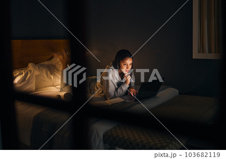 A little late night research. Cropped shot of an attractive young woman studying late at night in her bedroom at home. 103682119