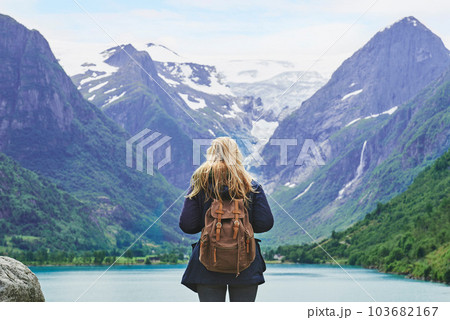 Adventure backpacking woman enjoying view of majestic mountain lake explore travel discover beautiful earth Adventure backpacking woman enjoying view of majestic mountain lake explore travel discover beautiful earth 103682167