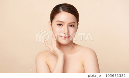 Beautiful young asian woman with clean fresh skin on beige background, Face care, Facial treatment, Cosmetology, beauty and spa, Asian women portrait. 103683322