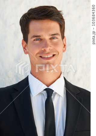 Handsome groom on the big day. Portrait of a handsome groom in a suit smiling at you. Handsome groom on the big day. Portrait of a handsome groom in a suit smiling at you. 103684360