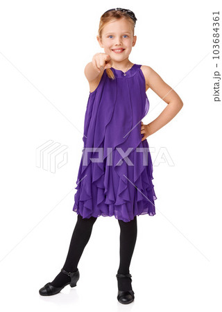 Fashion, pointing and portrait of child on a white background for youth, glamour and ballroom dancing. Happy, dancer and isolated young girl pointing finger with stylish, beautiful and trendy dress Fashion, pointing and portrait of child on a white background for youth, glamour and ballroom dancing. Happy, dancer and isolated young girl pointing finger with stylish, beautiful and trendy dress 103684361