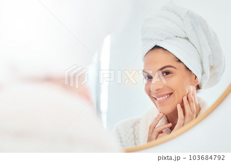 Woman, mirror and hands on face for skincare, smile and anti aging cosmetic results in bathroom. Facial, beauty and female touching soft, glow and smooth skin after luxury dermatology routine at home Woman, mirror and hands on face for skincare, smile and anti aging cosmetic results in bathroom. Facial, beauty and female touching soft, glow and smooth skin after luxury dermatology routine at home 103684792