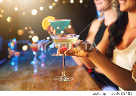 Getting the party started with some cocktails. women drinking cocktails in a nightclub. Getting the party started with some cocktails. women drinking cocktails in a nightclub. 103685488