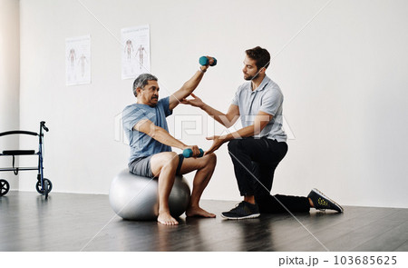 Dumbbells, physiotherapy and rehabilitation with doctor and patient for help, training and stretching. Healthcare, wellness and healing with old man and expert for consulting, muscle and exercise Dumbbells, physiotherapy and rehabilitation with doctor and patient for help, training and stretching. Healthcare, wellness and healing with old man and expert for consulting, muscle and exercise 103685625