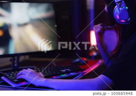 Female cyber hacker gamer watching monitor and making win gesture after hacking video games success 103685948