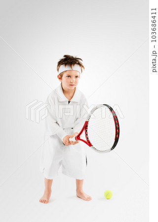 Meet tomorrows tennis champion. Studio shot of an adorable little boy dressing up as a tennis player. Meet tomorrows tennis champion. Studio shot of an adorable little boy dressing up as a tennis player. 103686411