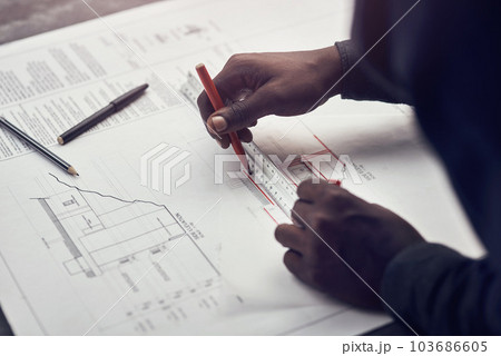 Putting his expertise to work. High angle shot of an unrecognizable male architect making some measurements on his blueprints in a modern office. 103686605
