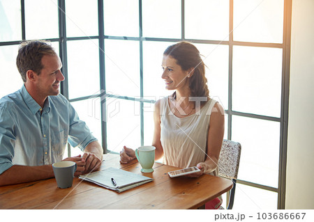 They never run out of things to talk about. a married couple using their tablet while drinking coffee together at home. 103686667