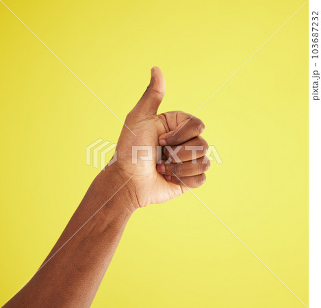 Dont just like it, love it. Studio shot of an unrecognisable man showing thumbs up against a yellow background. 103687232