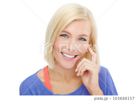 Endearing smile. Head and shoulders portrait of a beautiful young blonde isolated on a white background. 103688157