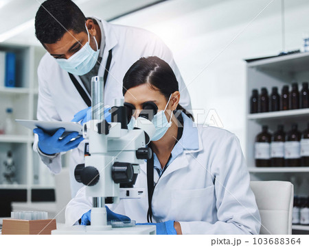 Science, tablet and man and woman with microscope for research, medical analysis and report in lab. Healthcare, biotechnology and team of scientists with equipment for sample, experiment and medicine 103688364