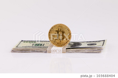 Dont tell me what you value, show me your budget. a coin and a wad of cash against a grey background. 103688404