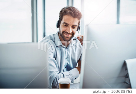 Call center, employee and man with telemarketing, customer service or communication in the workplace. Male person, consultant or agent with headphones, help and advice with tech support or consulting 103688762