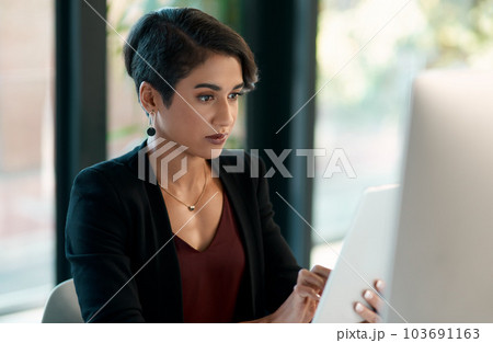Tablet, computer and business woman in office for website analysis, online management or technology solution. Review, typing or scroll of professional biracial person on desktop and digital software Tablet, computer and business woman in office for website analysis, online management or technology solution. Review, typing or scroll of professional biracial person on desktop and digital software 103691163
