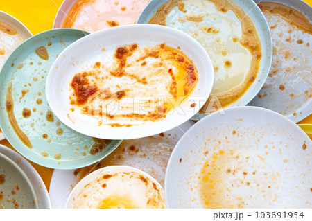 Dirty dishes on yellow background. Top view Dirty dishes on yellow background. Top view 103691954