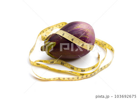 Measuring tape around eggplant on white background. Measuring tape around eggplant on white background. 103692675