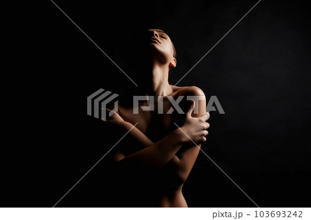 Nude Woman silhouette in the dark. Beautiful Naked Body Girl Nude Woman silhouette in the dark. Beautiful Naked Body Girl 103693242