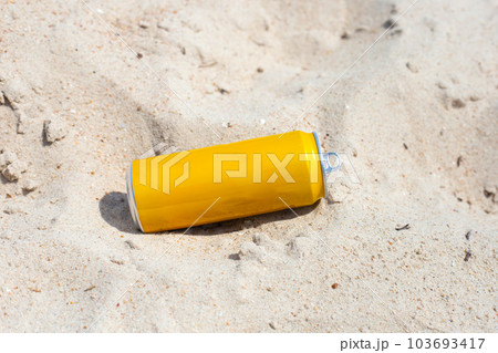 Yellow can waste on the beach 103693417