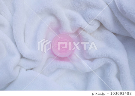 Fabric softener in measuring spoon on towel. Laundry concept. 103693488