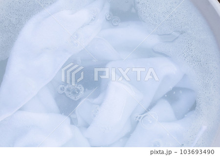 Top view of towel soak in powder detergent water dissolution. Laundry concept 103693490