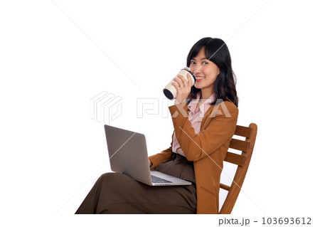 Beautiful young asian businesswoman using computer laptop sitting on wooden chair and drinking coffee isolate on white background. 103693612