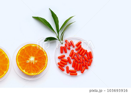 Vitamin C pills with  fresh orange citrus fruit isolated on white background. 103693916
