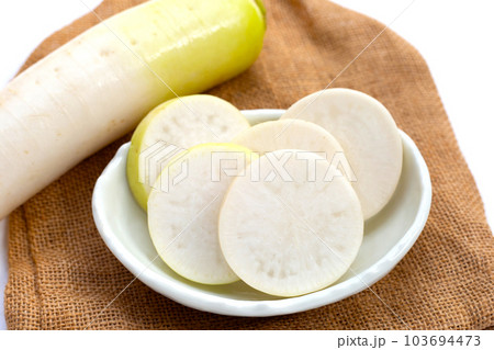 Sliced Japanese daikon. Fresh vegetables Sliced Japanese daikon. Fresh vegetables 103694473