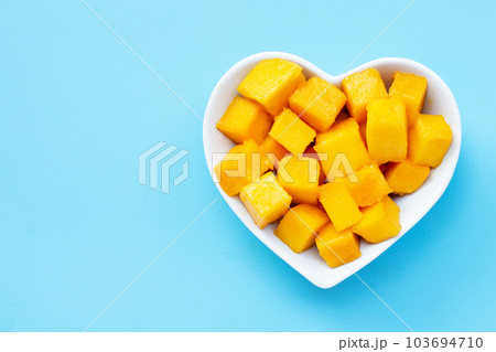 Tropical fruit, Mango on blue background. Top view Tropical fruit, Mango on blue background. Top view 103694710