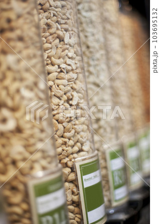 Food, grocery and shopping with nuts in supermarket for health, nutrition and retail offer. Choice, storage and vegan with grain products in zero waste packaging store for wellness, vegan and organic Food, grocery and shopping with nuts in supermarket for health, nutrition and retail offer. Choice, storage and vegan with grain products in zero waste packaging store for wellness, vegan and organic 103695132