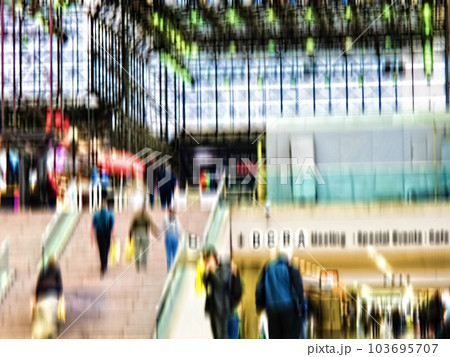 Busy scene with lots of people in blurry motion in Manhattan, New York. Men and woman walking out of a mall after shopping and doing daily routine tasks. Strangers walking up steps in a city 103695707