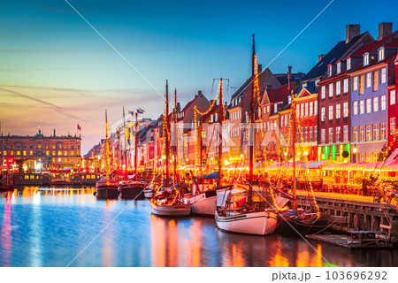 Copenhagen, Denmark. Nyhavn, Kobenhavn's iconic canal, colorful evening water reflection. 103696292