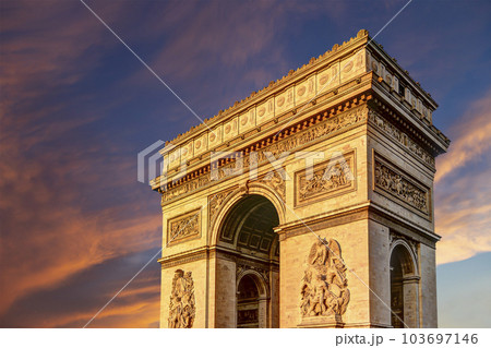 Arc de Triomphe (against the background of sky with clouds), Paris, France. The walls of the arch are engraved with the names of 128 battles and names of 660 French military leaders (in French) 103697146