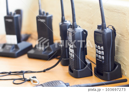 Charge, radio and walkie talkie for communication, equipment and battery with connection. Technology, tools and receiver with transmitter, portable and security with protection, energy and network Charge, radio and walkie talkie for communication, equipment and battery with connection. Technology, tools and receiver with transmitter, portable and security with protection, energy and network 103697273