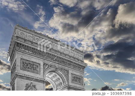 Arc de Triomphe (against the background of sky with clouds), Paris, France. The walls of the arch are engraved with the names of 128 battles and names of 660 French military leaders (in French) Arc de Triomphe (against the background of sky with clouds), Paris, France. The walls of the arch are engraved with the names of 128 battles and names of 660 French military leaders (in French) 103697398