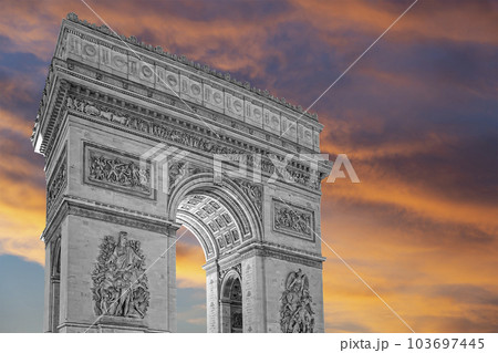 Arc de Triomphe (against the background of sky with clouds), Paris, France. The walls of the arch are engraved with the names of 128 battles and names of 660 French military leaders (in French) 103697445