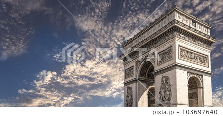 Arc de Triomphe (against the background of sky with clouds), Paris, France. The walls of the arch are engraved with the names of 128 battles and names of 660 French military leaders (in French) 103697640