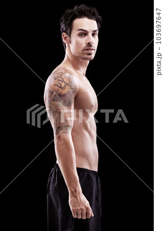 Portrait, man and bare bodybuilder on black background, dark studio and muscular abdomen tattoo. Sexy, serious and strong male model, sports athlete and fitness power for exercise, training or muscle 103697647