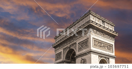 Arc de Triomphe (against the background of sky with clouds), Paris, France. The walls of the arch are engraved with the names of 128 battles and names of 660 French military leaders (in French) 103697751