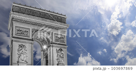 Arc de Triomphe (against the background of sky with clouds), Paris, France. The walls of the arch are engraved with the names of 128 battles and names of 660 French military leaders (in French) 103697869