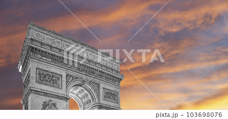 Arc de Triomphe (against the background of sky with clouds), Paris, France. The walls of the arch are engraved with the names of 128 battles and names of 660 French military leaders (in French) 103698076
