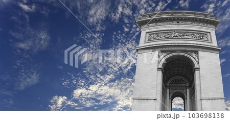 Arc de Triomphe (against the background of sky with clouds), Paris, France. The walls of the arch are engraved with the names of 128 battles and names of 660 French military leaders (in French) 103698138
