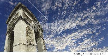 Arc de Triomphe (against the background of sky with clouds), Paris, France. The walls of the arch are engraved with the names of 128 battles and names of 660 French military leaders (in French) 103698139