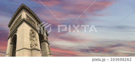 Arc de Triomphe (against the background of sky with clouds), Paris, France. The walls of the arch are engraved with the names of 128 battles and names of 660 French military leaders (in French) 103698262
