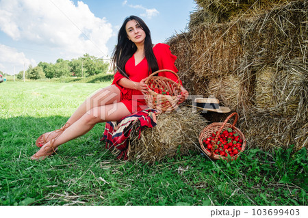 Portrait of Smiling Woman with Basket of Strawberries 103699403