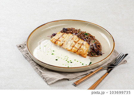 Halibut fillet with soba noodles and creamy sauce Halibut fillet with soba noodles and creamy sauce 103699735