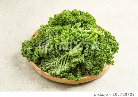 Fresh kale leaves on light grey table 103700705